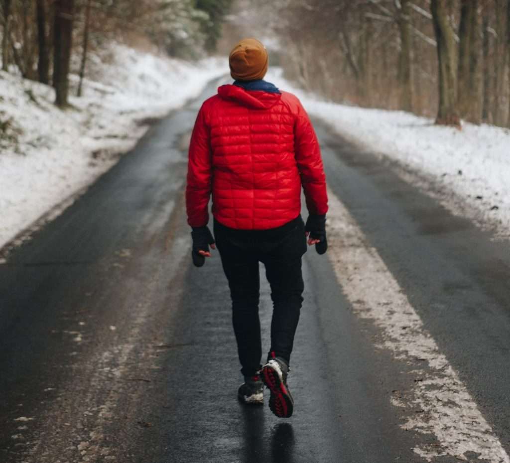 Man walking down a snowy road